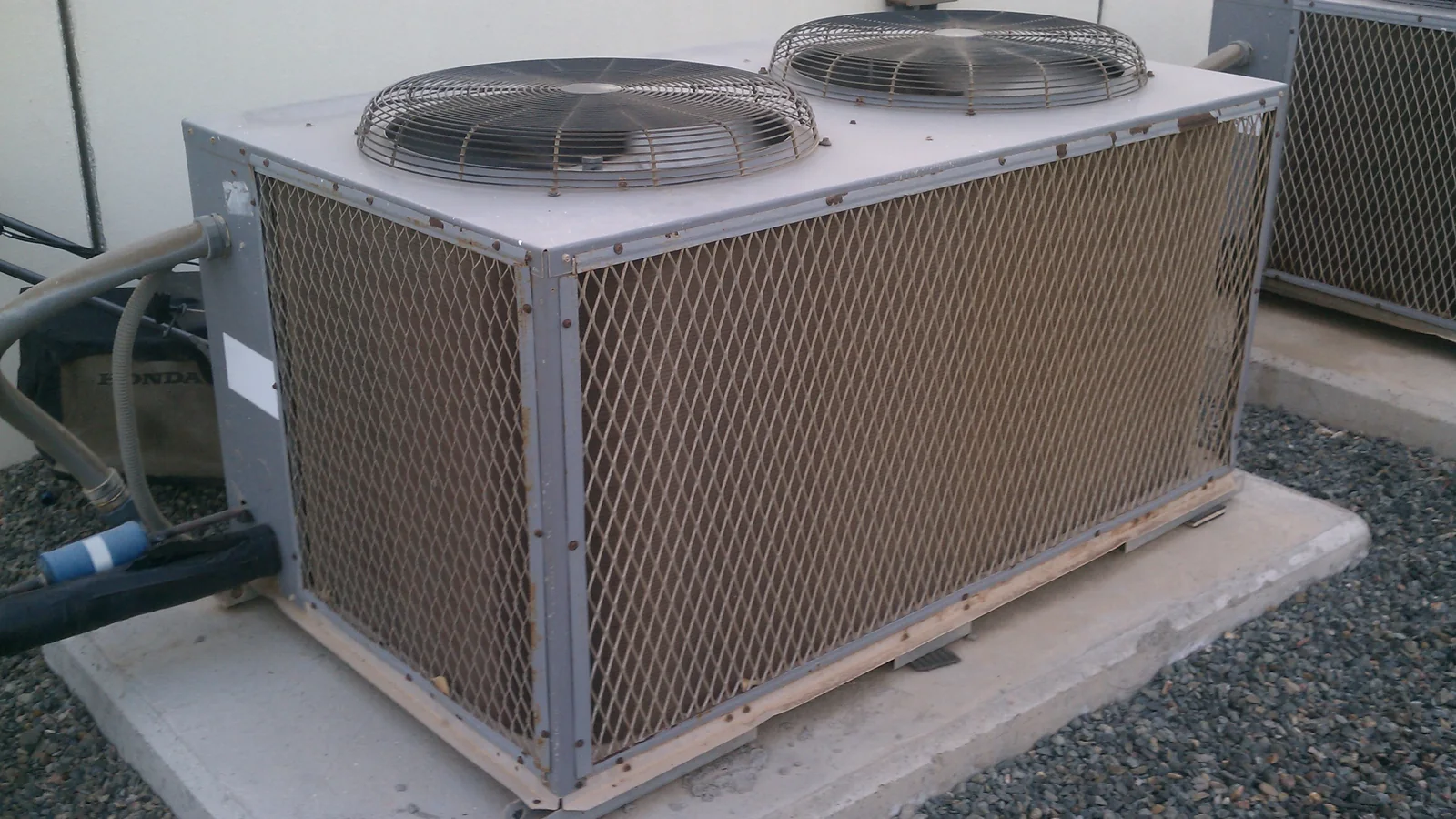 A modern residential air conditioning unit photographed outdoors on a sunny day.